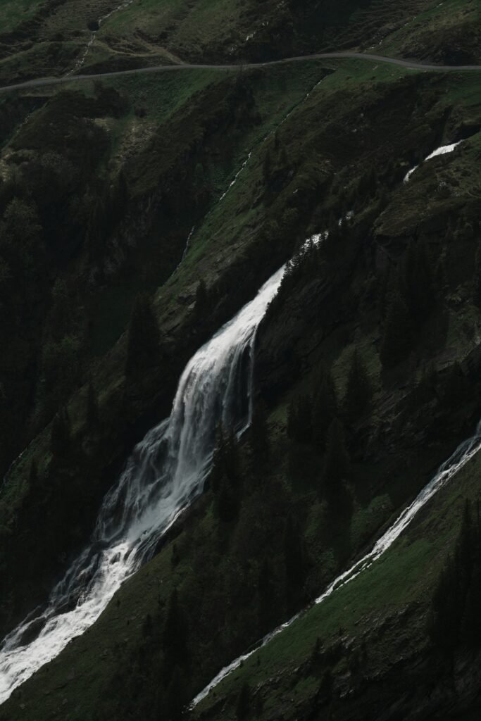 A view of a mountain with a waterfall in the middle of it